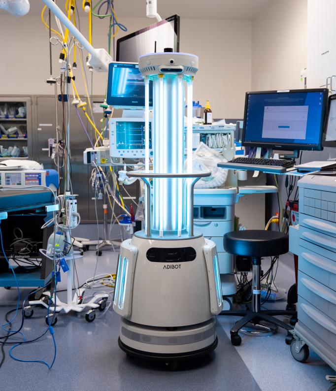 The ADIBOT A1 fully autonomous UV-C disinfection robot with UV-C lamps on disinfecting an operating room in a hospital.
